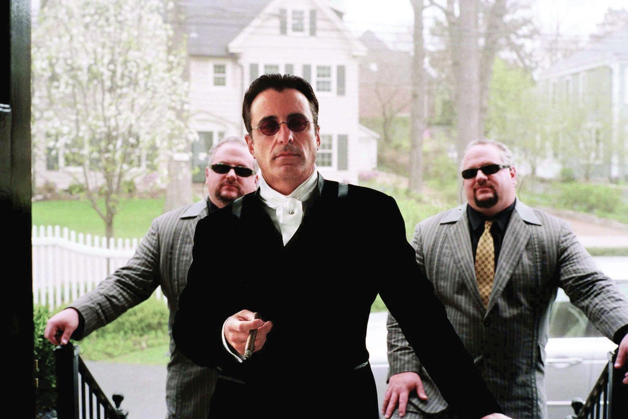 Scene from Ocean's Twelve: Terry Benedict with this goons, looking suave, standing on a doorway. Beautiful shot with nice texture and film grain.