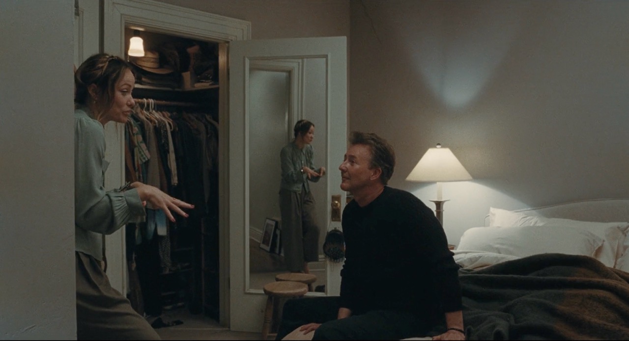 Scene from The Invite: Two of the cast members talking in a lamp lit bedroom